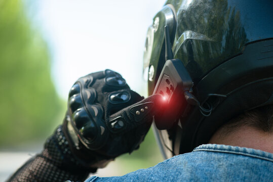 Motorbiker Is Using A Phone Headset On His Helmet Close Up.