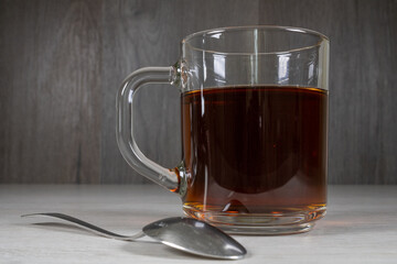 Glass cup with tea on a dark background.