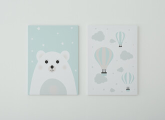 Adorable pictures of bear and air balloons on white wall. Children's room interior elements