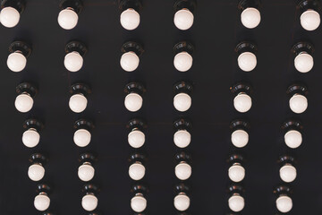Pattern of light bulbs taken from above against black