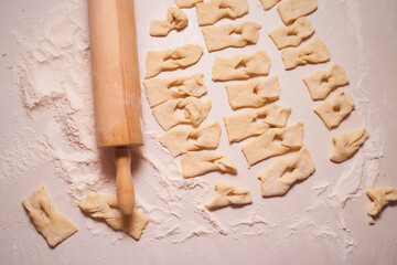 Homemade pastry, sprinkled with powdered sugar on a light table