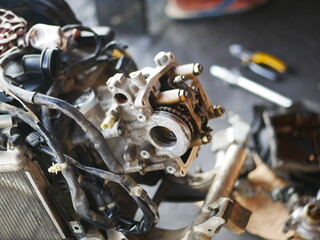 Fototapeta na wymiar Mechanic working on motorcycle engine in workshop. 