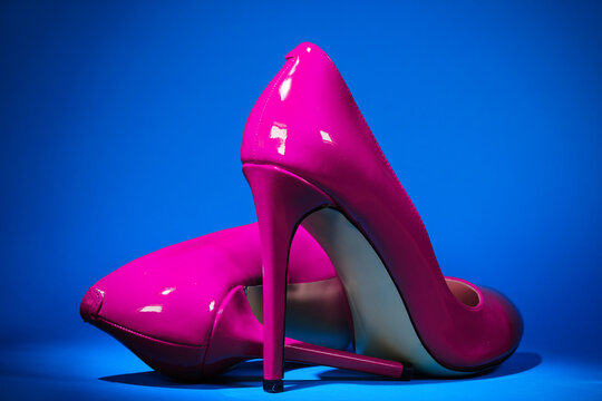 Patent Leather Shiny Female Pink Stilettos On A Blue Background