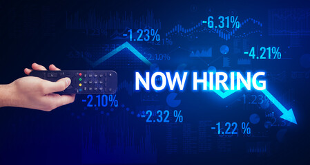 male hand holding wireless peripheral with NOW HIRING inscription, modern business concept