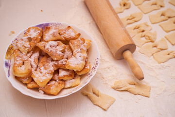 Homemade pastry, sprinkled with powdered sugar on a light table