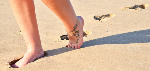 Walking on the beach while on holiday in the UK, Cumbria, England, UK
