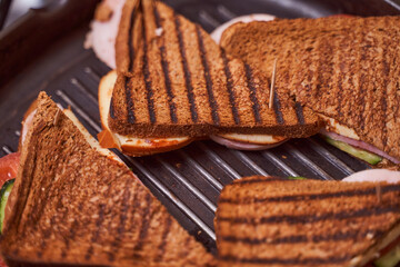 Homemade sandwiches lie on the groa grill