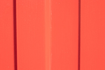 Red metal wall background with copy space. Colorful texture
