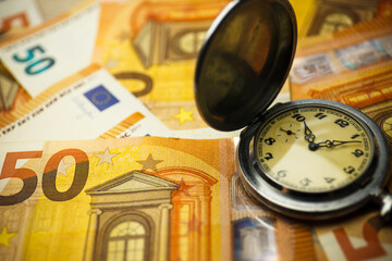 Time is money concept with euros banknotes.