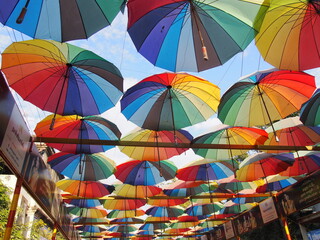 Fototapeta na wymiar A rainbow-colored umbrella adorns the sky above, Madurai, Tamil Nadu, South India, India
