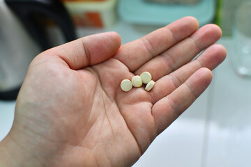 Adult male hand full of pills