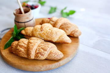 Traditional French croissant on white table background