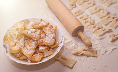 Homemade pastry, sprinkled with powdered sugar on a light table