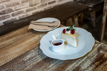 Crepes cake with raspberry blueberry and blueberry jam on wood table.
