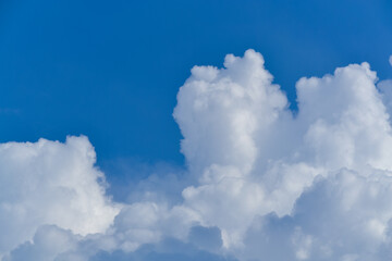 Naklejka na ściany i meble cumulus white clouds in a blue sky
