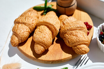 Traditional French croissant on white table background