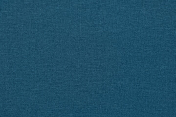 Blue background with a textured surface, fabric.