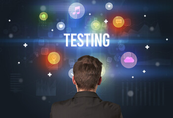 Rear view of a businessman with TESTING inscription, modern technology concept