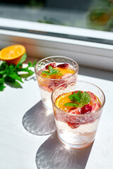 Summer cocktail with strawberry, orange and mint in glass