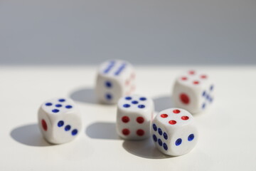 Five dice with different numbers on a white sunny table