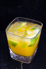cocktail with lime, orange juice and ice. 