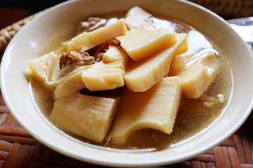 Homemade Bamboo Shoot boiled with pork bones soup in white bowl is tradition thai food.