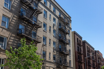 Row of Old Brick Residential Buildings with Fire Escapes in Sunnyside Queens New York	