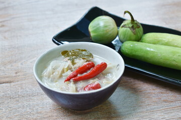 herb soybean sauce with pickled fish and Budu Thai southern sauce in coconut milk sauce served couple boiled vegetable on plate