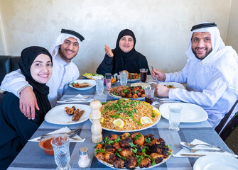 Happy arabic muslim family enjoying the food togther in ramadan