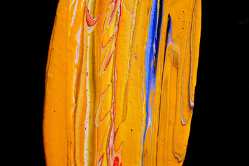 Colorful oil paint shape black canvas background.
