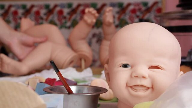 Making baby reborn doll. Workplace for the master of making dolls. Preparation of parts for baking in the oven