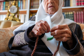 Arabic muslim man praying for god using rosary