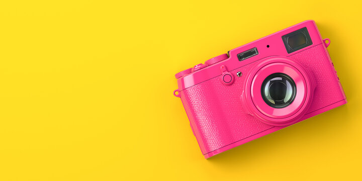 Pink Vintage Photo Camera On Yellow Background.