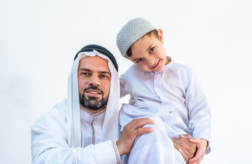 Arabic muslim father holding his son on his shoulder