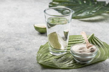 Collagen Powder and glass of water with  slice of Lime; Vitamin C . Collagen supplements may...