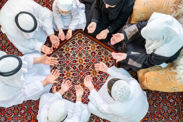 Happy arabic family praying for god during ramadan
