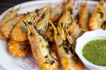 
Grilled shrimp and dipping sauce put on a plate ready to serve