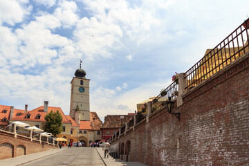 SIBIU, ROMANIA - Circa 2020: Old medieval town brick wall with cloudy blue sky. Beautiful tourist spot in eastern central Europe. Famous Tower of Council in Sibiu Romania