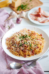 pasta carbonara with tomato sauce and parmesan