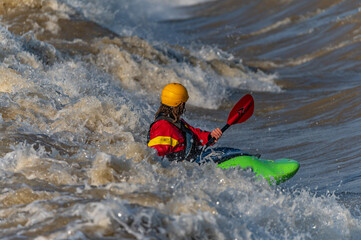 a freestyle kayaker on the river