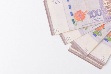 Malaysia Currency (MYR) Ringgit Malaysia bank note. Close up on money showing the first of Malaysian King on Rm100 notes.