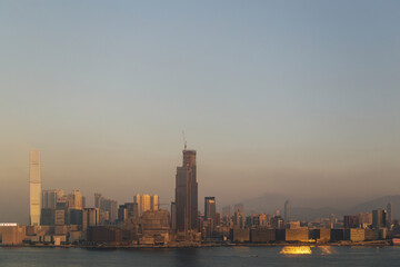Fototapeta na wymiar HONG KONG, CHINA - CIRCA 2020: Hong Kong Skyline and Victoria Harbor in morning. Sunset over Hong Kong bay on a clear day