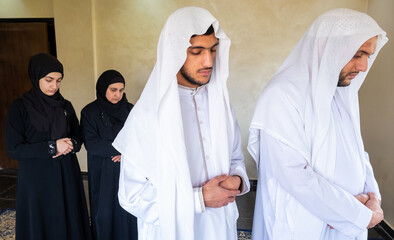 Muslim family memebers praying dohor togther