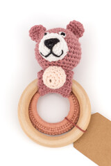 knitted brown bear on a wooden ring