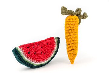 Knitted carrot and watermelon on white background