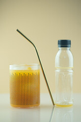 Fresh orange juice in glass pour from plastic bottle