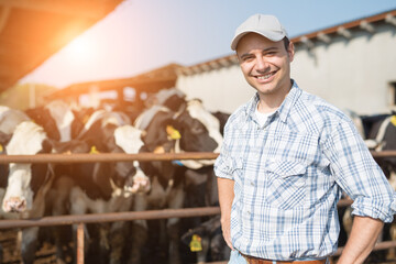 Breeder in front of cows