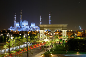 Fototapeta na wymiar Abu Dhabi, UAE - CIRCA 2020: Beautiful view of Sheik Zayed Grand mosque. Night view of mosque with colorful illumination. Concept of Islam faith and spirituality