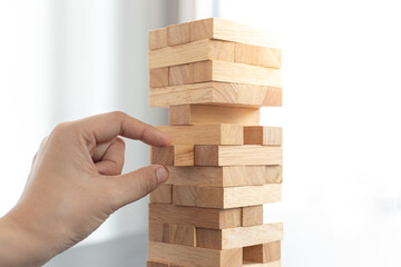 Businessman playing a wooden game in his office.