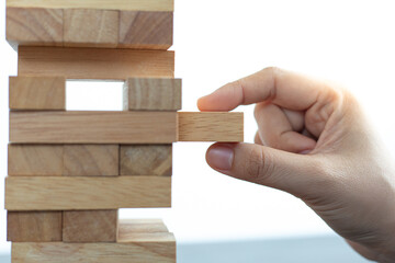 Businessman playing a wooden game in his office.